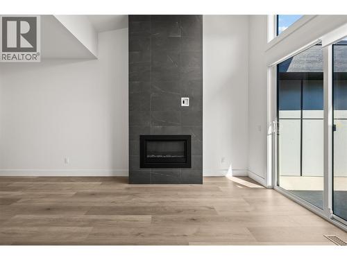 Living room. Photos taken from similar home in the community. - 2835 Canyon Crest Drive Unit# 7, West Kelowna, BC - Indoor With Fireplace