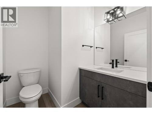 Main floor powder room. Photos taken from similar home in the community. - 2835 Canyon Crest Drive Unit# 7, West Kelowna, BC - Indoor Photo Showing Bathroom