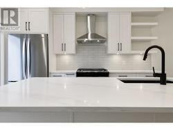 Galley style kitchen with oversized island with seating for 4 ppl and patio off of kitchen. - 