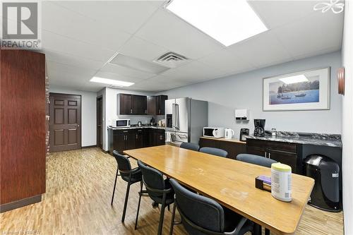 Dining space with a drop ceiling, light wood-style floors, and an office area - 207 Greenwich Street, Brantford, ON 