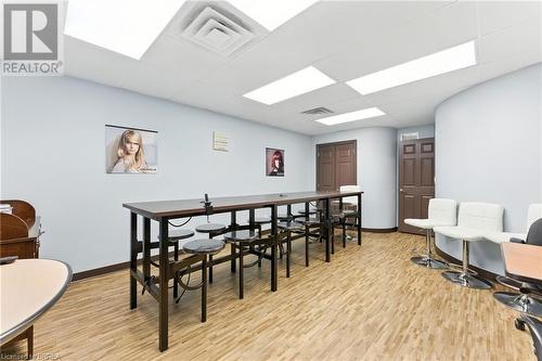 Dining space featuring wood finished floors and a paneled ceiling - 207 Greenwich Street, Brantford, ON 