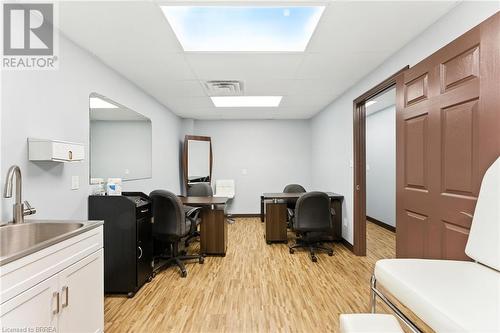 Office space featuring light wood-type flooring and a drop ceiling - 207 Greenwich Street, Brantford, ON 
