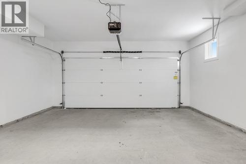 Photos are of a similar home in the community. - 5300 Main Street Unit# 115, Kelowna, BC - Indoor Photo Showing Garage