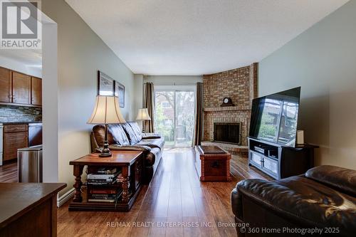 w/o to Yard from Family room * fireplace - 4425 Sawmill Valley Drive, Mississauga, ON - Indoor Photo Showing Living Room With Fireplace