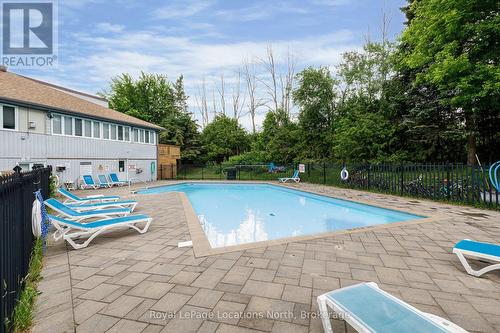Pool BACKING INTO  green space - Unit 18 - 209472 26 Highway, Blue Mountains, ON - Outdoor With In Ground Pool With Deck Patio Veranda With Backyard