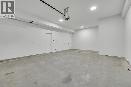 Photos may be of a similar home in the community - 5300 Main Street Unit# 124, Kelowna, BC - Indoor Photo Showing Garage