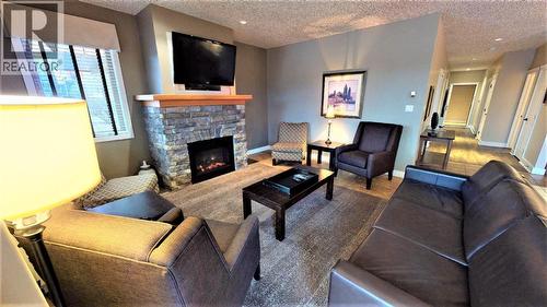 400 Bighorn Boulevard Unit# 416 F, Radium Hot Springs, BC - Indoor Photo Showing Living Room With Fireplace