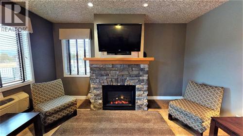 400 Bighorn Boulevard Unit# 416 F, Radium Hot Springs, BC - Indoor Photo Showing Living Room With Fireplace