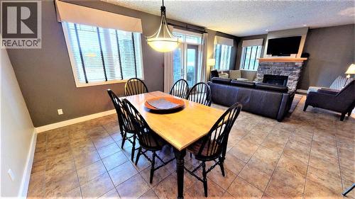 400 Bighorn Boulevard Unit# 416 F, Radium Hot Springs, BC - Indoor Photo Showing Dining Room With Fireplace