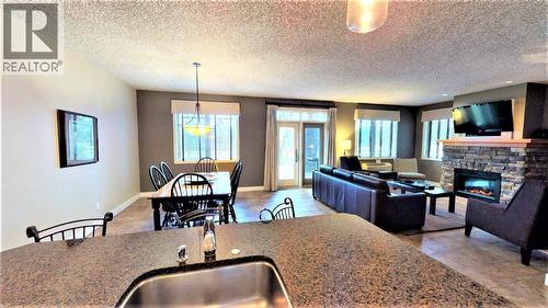 400 Bighorn Boulevard Unit# 416 F, Radium Hot Springs, BC - Indoor Photo Showing Living Room With Fireplace