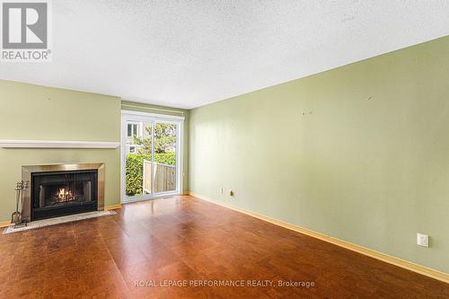 Living Rm w/fireplace & sliding doors to backyard - 2015 Summerfields Crescent, Ottawa, ON - Indoor Photo Showing Living Room With Fireplace