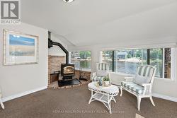a lovely sunroom with a fireplace insert - 