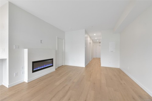 203-9716 Third St, Sidney, BC - Indoor Photo Showing Other Room With Fireplace