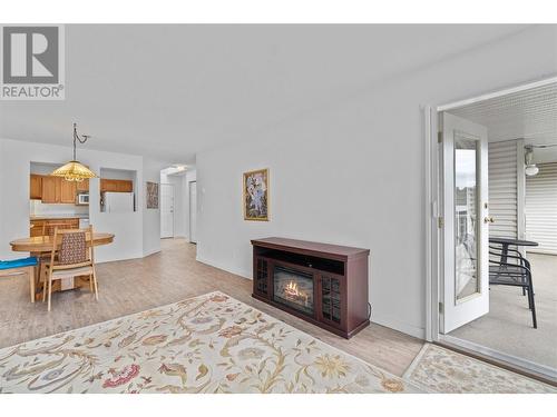 Living room to deck - 250 5 Street Se Unit# 313, Salmon Arm, BC - Indoor Photo Showing Living Room With Fireplace