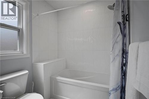 Bathroom with shower / bath combination with curtain and toilet - 47 Gruhn Street, Kitchener, ON - Indoor Photo Showing Bathroom