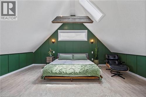 Bedroom with a decorative wall, wood finished floors, vaulted ceiling, and a skylight - 47 Gruhn Street, Kitchener, ON - Indoor Photo Showing Bedroom