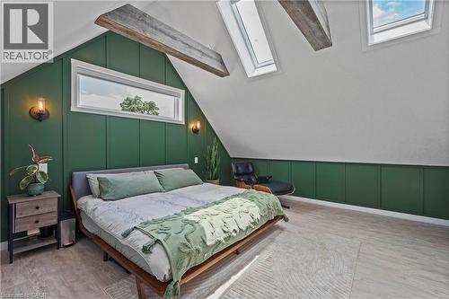 Bedroom with a skylight, a decorative wall, wood finished floors, and lofted ceiling - 47 Gruhn Street, Kitchener, ON - Indoor Photo Showing Bedroom