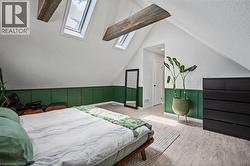 Bedroom with a skylight and wood finished floors - 