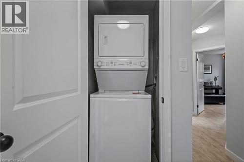 Washroom with stacked washing machine and dryer and light wood finished floors - 47 Gruhn Street, Kitchener, ON - Indoor Photo Showing Laundry Room