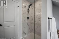 Full bathroom with a marble finish shower - 