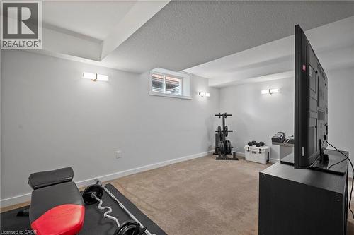 Workout room featuring carpet flooring and a textured ceiling - 47 Gruhn Street, Kitchener, ON - Indoor
