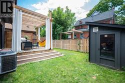 View of yard featuring a deck, a pergola, and a shed - 