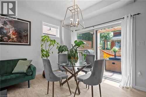Dining space with wood finished floors and a chandelier - 47 Gruhn Street, Kitchener, ON - Indoor Photo Showing Dining Room
