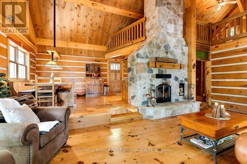2275 Palmerston Lake, Frontenac (Frontenac North), ON - Indoor Photo Showing Living Room With Fireplace