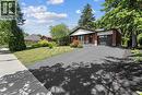 View of front of home with an attached garage, brick siding, asphalt driveway, and a front lawn - 79 Inwood Crescent, Kitchener, ON  - Outdoor 