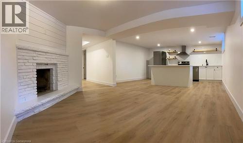 Unfurnished living room with light wood-style floors, recessed lighting, and a fireplace - 79 Inwood Crescent, Kitchener, ON - Indoor With Fireplace