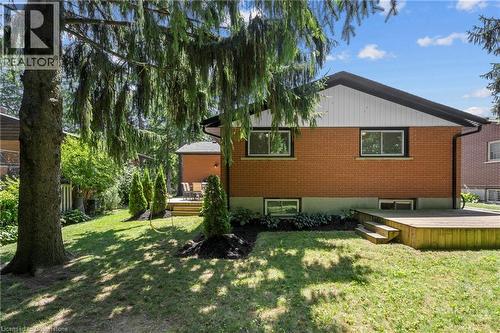 Back of house with a wooden deck, brick siding, and a yard - 79 Inwood Crescent, Kitchener, ON - Outdoor