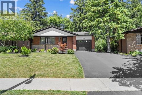 View of front facade with a garage, driveway, a front lawn, and brick siding - 79 Inwood Crescent, Kitchener, ON - Outdoor