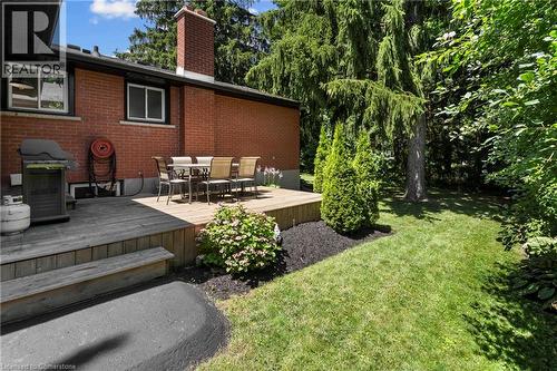 View of green lawn with outdoor dining area and a wooden deck - 79 Inwood Crescent, Kitchener, ON - Outdoor With Deck Patio Veranda