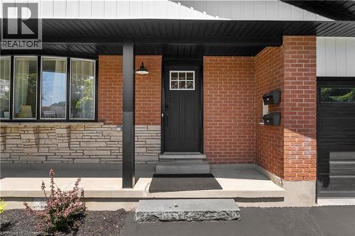 Property entrance with stone siding, brick siding, and a porch - 79 Inwood Crescent, Kitchener, ON - Outdoor