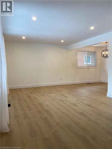 Unfurnished room featuring wood finished floors, recessed lighting, and a chandelier - 79 Inwood Crescent, Kitchener, ON - Indoor