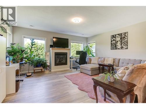 Living room in suite - 1420 Bentien Road, Kelowna, BC - Indoor Photo Showing Living Room With Fireplace