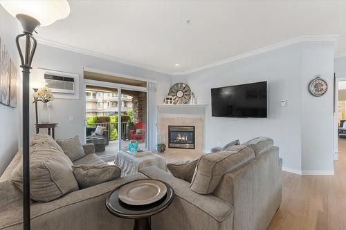 113-1962 Enterprise Way, Kelowna, BC - Indoor Photo Showing Living Room With Fireplace