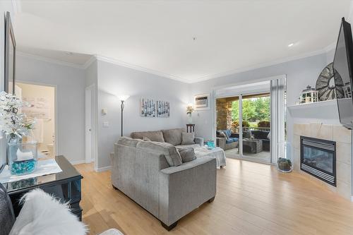 113-1962 Enterprise Way, Kelowna, BC - Indoor Photo Showing Living Room With Fireplace