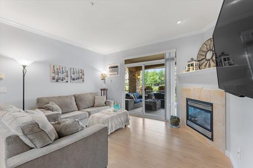 113-1962 Enterprise Way, Kelowna, BC - Indoor Photo Showing Living Room With Fireplace