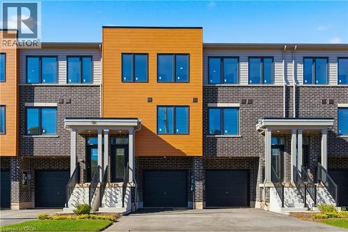 Modern home with driveway, a garage, and brick siding - 9B Bingham Road, Hamilton, ON - Outdoor With Facade