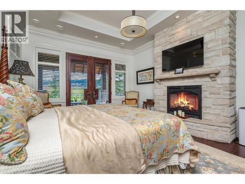 602 Falcon Point Way, Vernon, BC - Indoor Photo Showing Bedroom With Fireplace