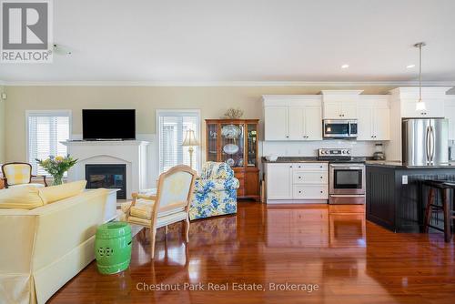 Open floor plan living- engineered hardwood floors - 77 Findlay Drive, Collingwood, ON - Indoor Photo Showing Kitchen With Fireplace With Upgraded Kitchen