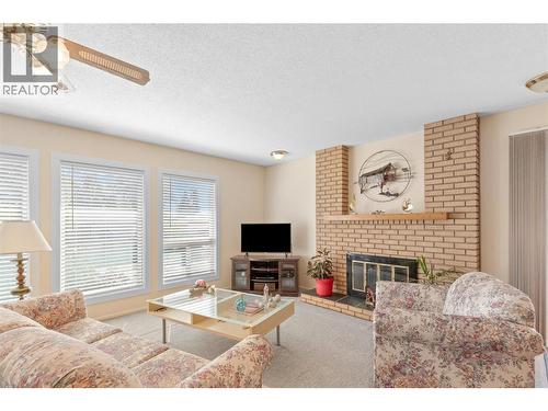 LIVINGROOM - Brick surrounded Wood-burning fireplace! - 3011 11 Street, Vernon, BC - Indoor Photo Showing Living Room With Fireplace