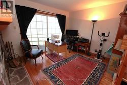 Sitting room/main floor bedroom with fireplace. - 