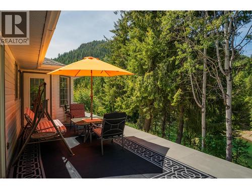 Patio in the main house that overlooks the river. - 2697 Osachoff Road, South Slocan, BC - Outdoor With Deck Patio Veranda