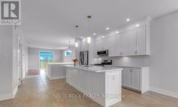 Looking from dining area to kitchen/living area - 