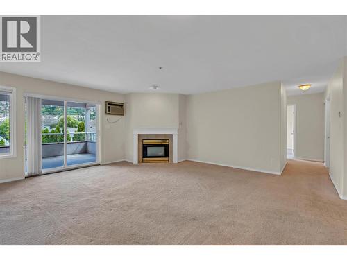3310 Skaha Lake Road Unit# 306, Penticton, BC - Indoor Photo Showing Living Room With Fireplace