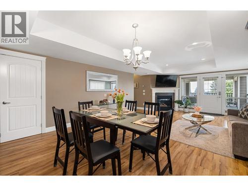 374 Trumpeter Court, Kelowna, BC - Indoor Photo Showing Dining Room With Fireplace