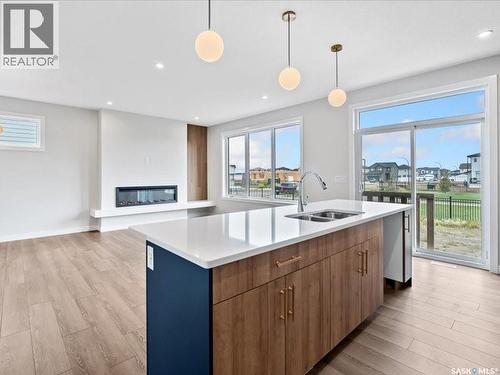 107 Katz Avenue, Saskatoon, SK - Indoor Photo Showing Kitchen With Fireplace With Double Sink