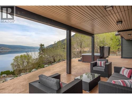 Partially covered lower level patio - 7172 Brent Road, Peachland, BC - Outdoor With Body Of Water With Deck Patio Veranda With Exterior